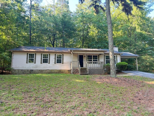 ranch-style house featuring a carport and a front lawn