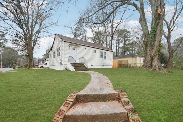 rear view of property with a lawn