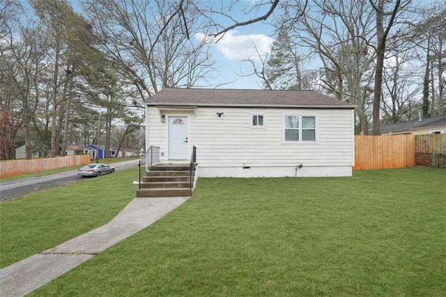 rear view of house with a lawn