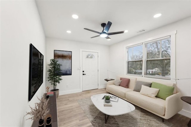 living room with ceiling fan and light wood-type flooring