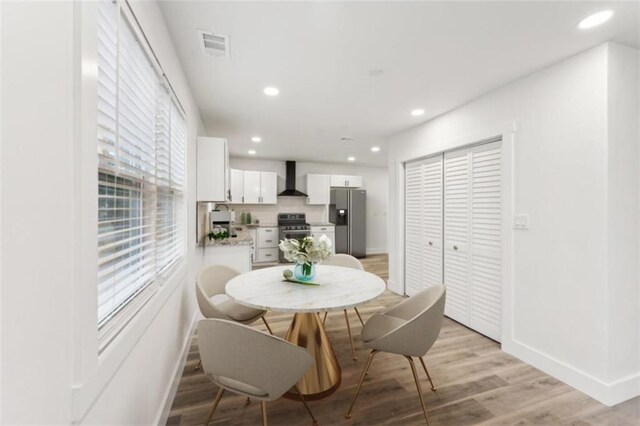 dining area with sink and light hardwood / wood-style floors