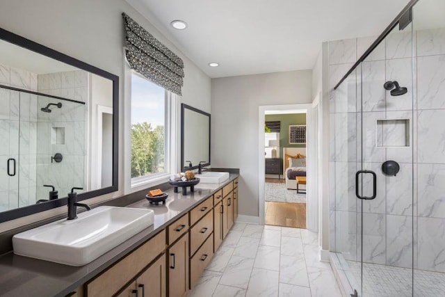 bathroom with a shower with door and vanity