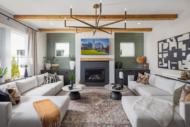 living room with beam ceiling and a healthy amount of sunlight