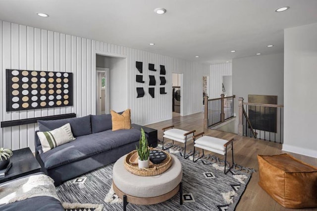 living room with washer / dryer and wood-type flooring