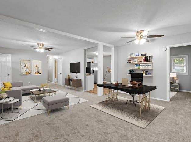 living room with light colored carpet and ceiling fan