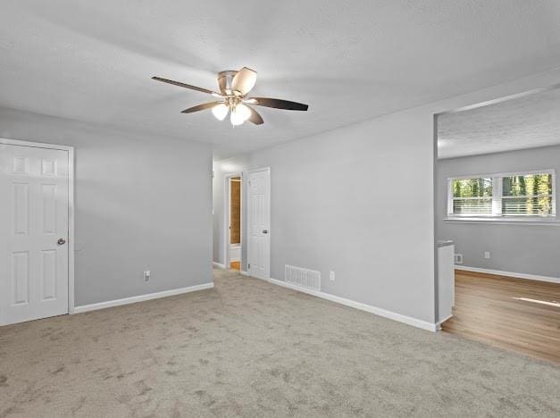 empty room featuring carpet and ceiling fan