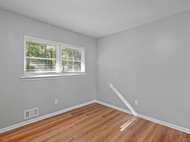 unfurnished room featuring hardwood / wood-style flooring