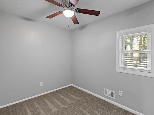 empty room with ceiling fan and carpet floors