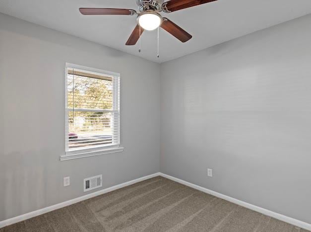 carpeted spare room with ceiling fan