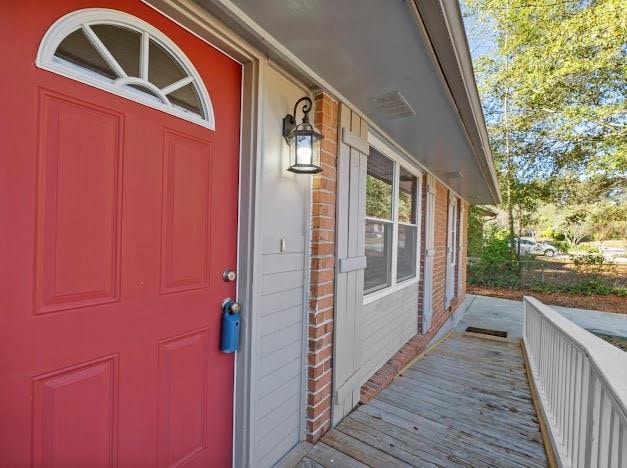 view of exterior entry with a porch