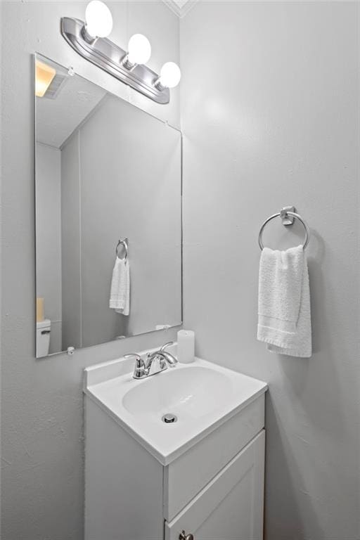 bathroom featuring vanity and ornamental molding