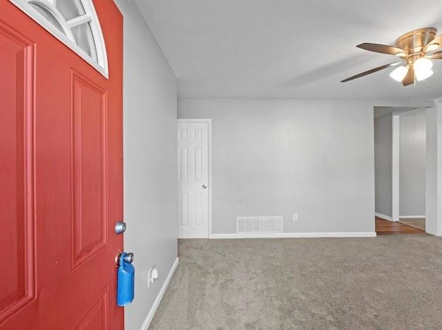 carpeted empty room with ceiling fan