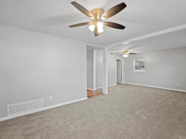 unfurnished room with ceiling fan, carpet floors, and a textured ceiling