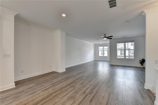 unfurnished living room with wood finished floors, ornamental molding, and a ceiling fan