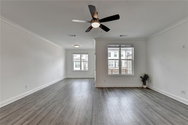 unfurnished room featuring visible vents, crown molding, baseboards, dark wood finished floors, and a ceiling fan