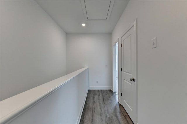 corridor with recessed lighting, baseboards, attic access, and wood finished floors