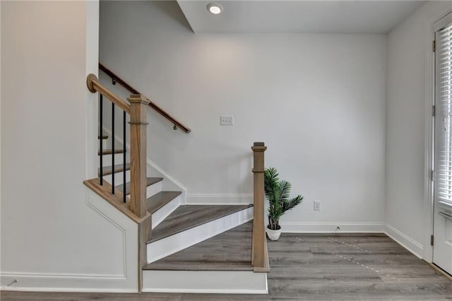 stairs with recessed lighting, a healthy amount of sunlight, baseboards, and wood finished floors