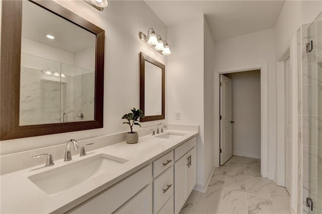 bathroom with a sink, marble finish floor, a stall shower, and double vanity