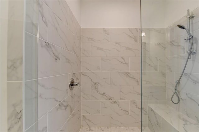 bathroom with a tile shower