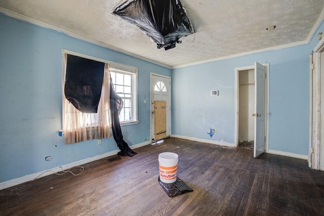 interior space with ornamental molding, dark hardwood / wood-style flooring, and a textured ceiling