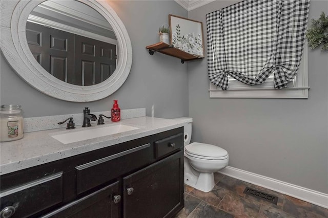 bathroom featuring visible vents, baseboards, toilet, stone finish flooring, and vanity