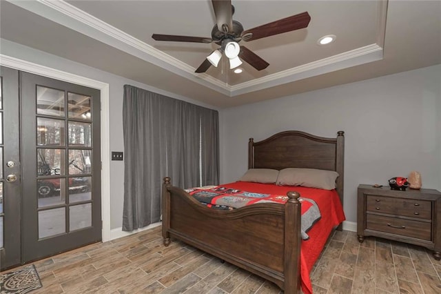 bedroom featuring wood tiled floor, a raised ceiling, crown molding, and recessed lighting