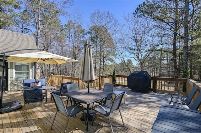 wooden deck with an outdoor living space, outdoor dining area, and area for grilling