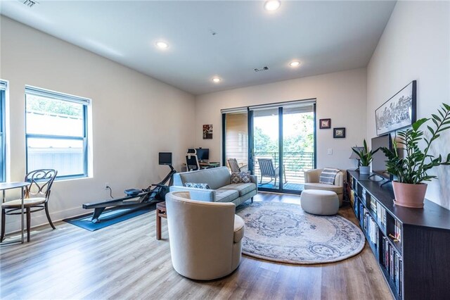 living room with recessed lighting, baseboards, visible vents, and wood finished floors