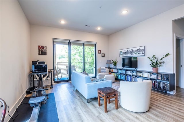 living room featuring baseboards, recessed lighting, light wood-style flooring, and visible vents