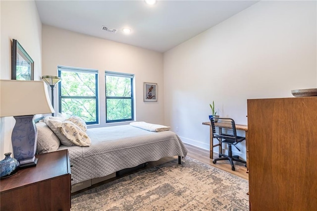 bedroom with visible vents, recessed lighting, baseboards, and wood finished floors