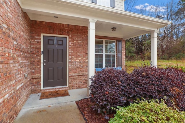 view of exterior entry with a porch