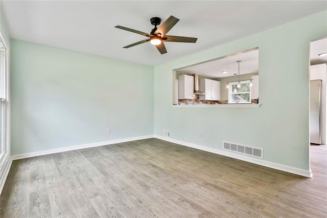 191 Pine St NE, Fairburn, GA 30213 - spare room featuring a ceiling fan, wood finished floors, and baseboards