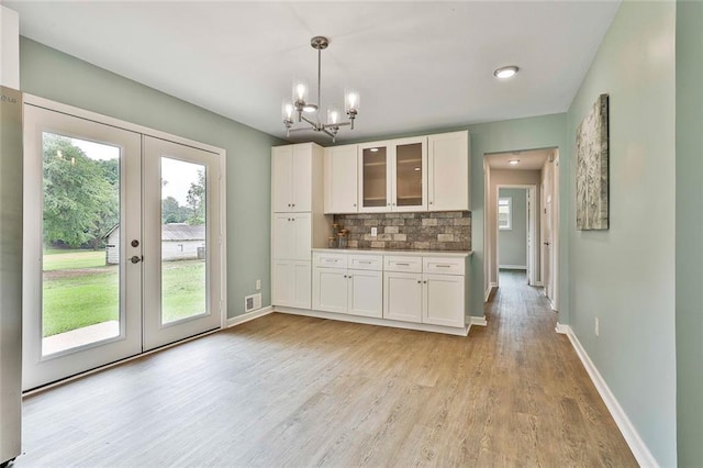 191 Pine St NE, Fairburn, GA 30213 - kitchen featuring french doors, white cabinets, plenty of natural light, and a chandelier