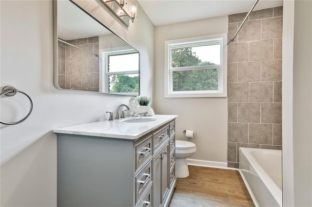191 Pine St NE, Fairburn, GA 30213 - bathroom with vanity, toilet, wood finished floors, baseboards, and bathtub / shower combination