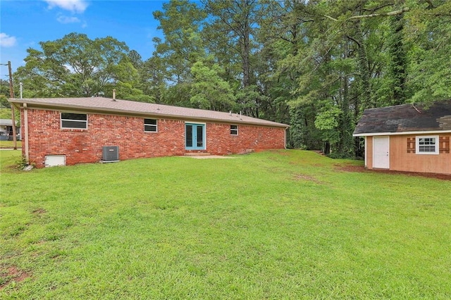 191 Pine St NE, Fairburn, GA 30213 - back of house with central AC, a yard, and brick siding