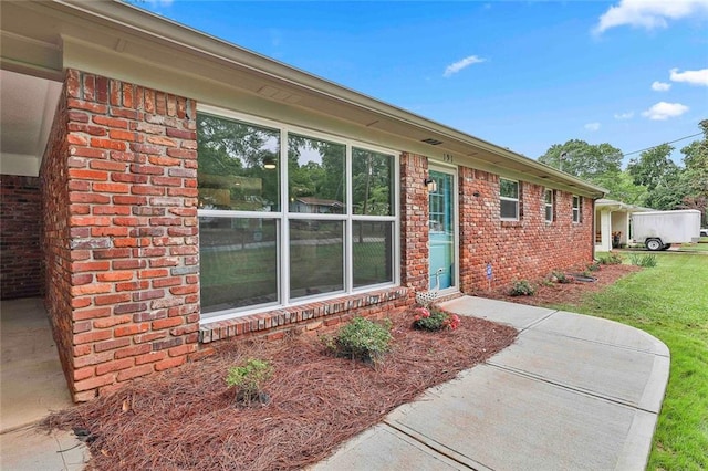 191 Pine St NE, Fairburn, GA 30213 - view of exterior entry with brick siding and a yard
