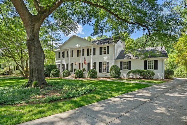 greek revival house with a front lawn