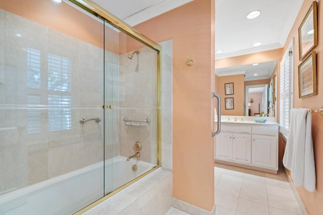 bathroom featuring ornamental molding, tile patterned flooring, tiled shower / bath combo, vanity, and baseboards
