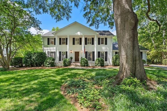 greek revival house with a front lawn