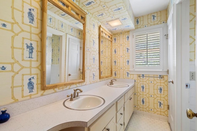 bathroom with wallpapered walls, tile patterned flooring, and double vanity