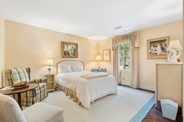 bedroom featuring baseboards and wood finished floors