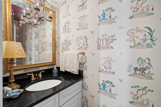 bathroom with a chandelier and vanity