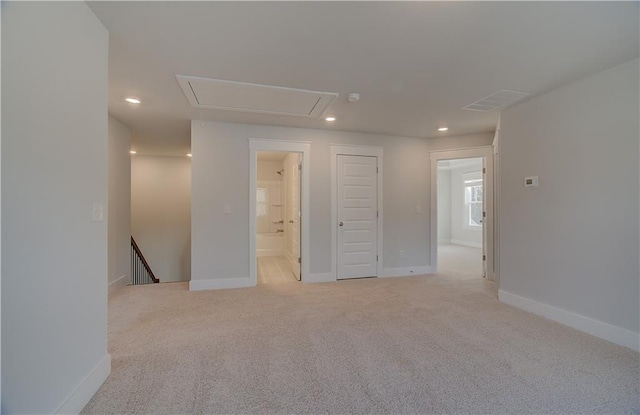 unfurnished room featuring recessed lighting, visible vents, light colored carpet, and attic access