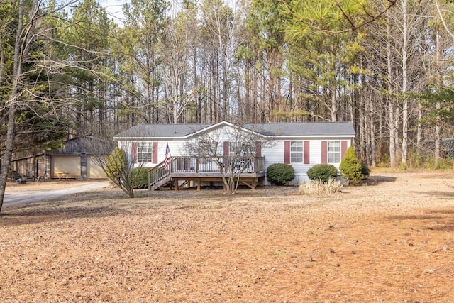 view of front of home with a garage and a deck