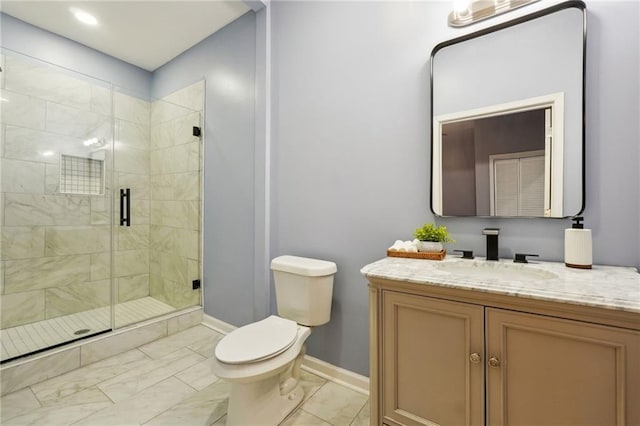 bathroom featuring toilet, a shower with door, and vanity