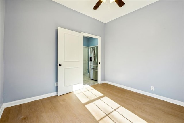 spare room featuring ceiling fan and hardwood / wood-style floors