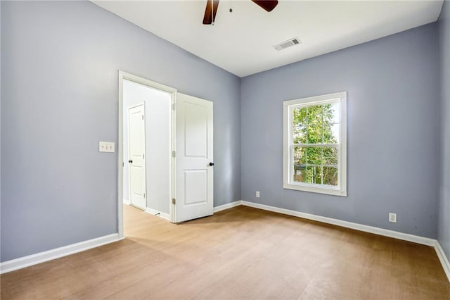 empty room with ceiling fan and light wood-type flooring