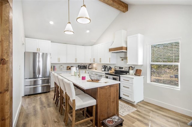 kitchen with stainless steel appliances, light countertops, custom range hood, beamed ceiling, and a kitchen bar