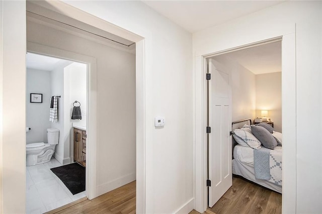 hallway with light wood finished floors and baseboards