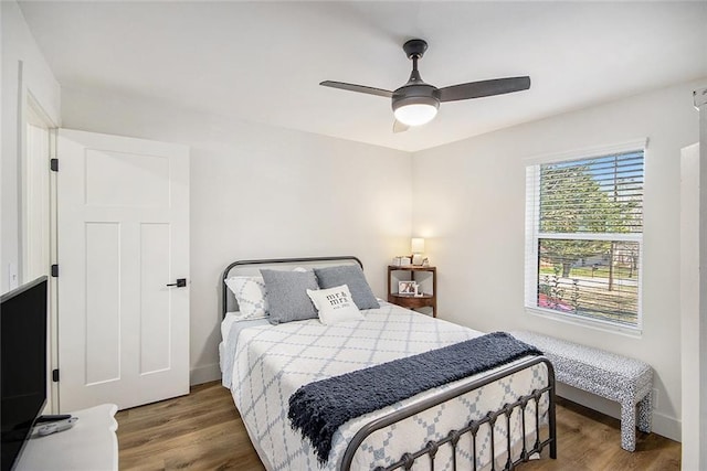 bedroom with a ceiling fan and wood finished floors